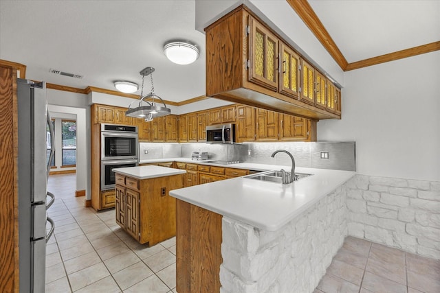 4029 Whiterock Trl, Garland, TX 75043 - kitchen featuring stainless steel appliances, ornamental molding, a peninsula, light countertops, and brown cabinetry