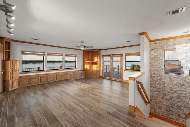 4029 Whiterock Trl, Garland, TX 75043 - unfurnished living room featuring crown molding, a ceiling fan, wood finished floors, baseboards, and a chandelier