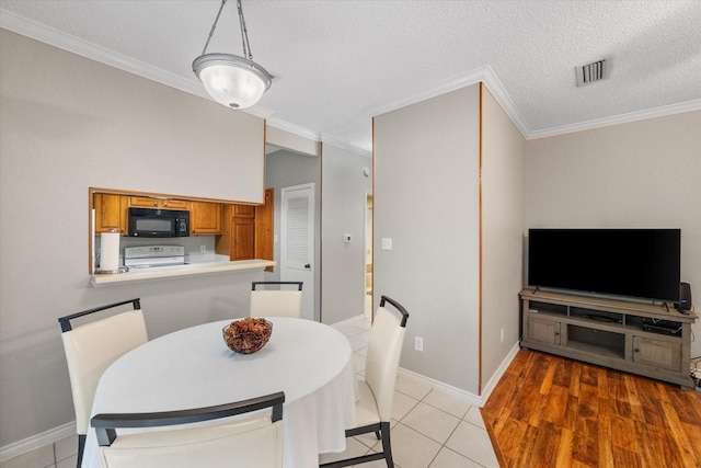 2101 Saint Michaels Dr Unit 109, Arlington, TX 76011 - dining space featuring ornamental molding, baseboards, and light tile patterned floors