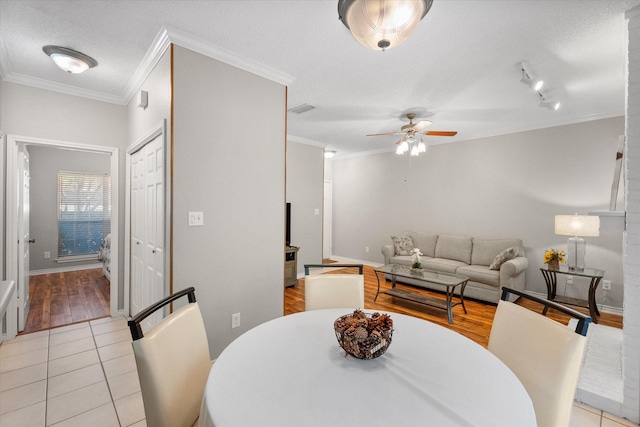 2101 Saint Michaels Dr Unit 109, Arlington, TX 76011 - dining space featuring ornamental molding, ceiling fan, wood finished floors, and baseboards