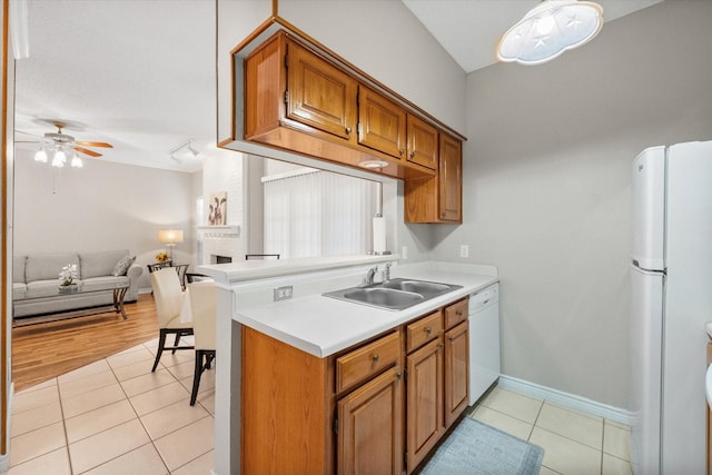 2101 Saint Michaels Dr Unit 109, Arlington, TX 76011 - kitchen featuring a sink, white appliances, light tile patterned flooring, brown cabinets, and light countertops