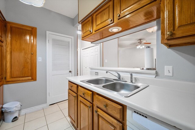 2101 Saint Michaels Dr Unit 109, Arlington, TX 76011 - kitchen featuring a sink, brown cabinets, light tile patterned flooring, and light countertops