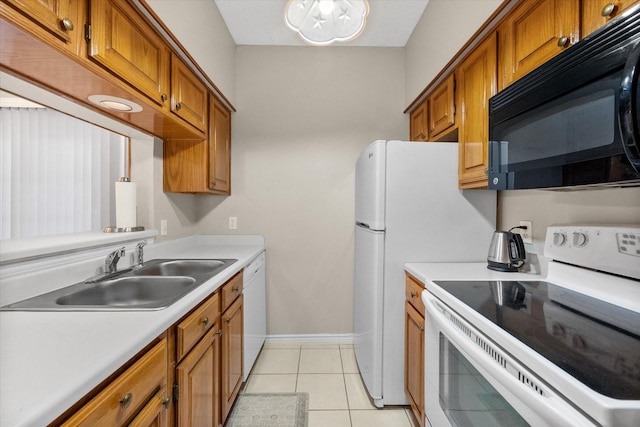 2101 Saint Michaels Dr Unit 109, Arlington, TX 76011 - kitchen with white appliances, a sink, brown cabinets, and light countertops