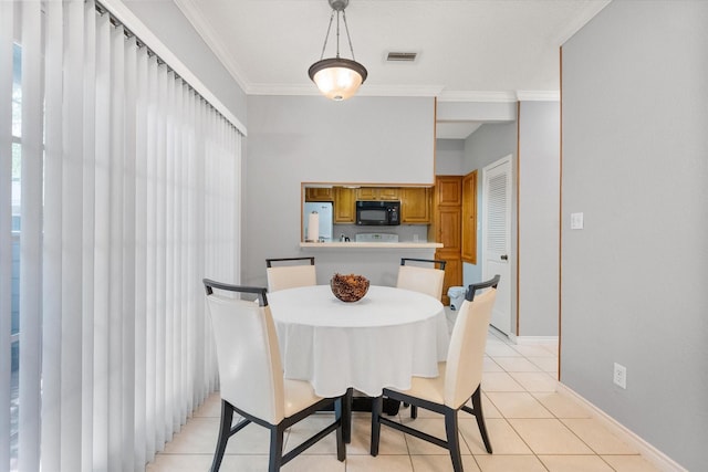 2101 Saint Michaels Dr Unit 109, Arlington, TX 76011 - dining area featuring light tile patterned floors, crown molding, and baseboards