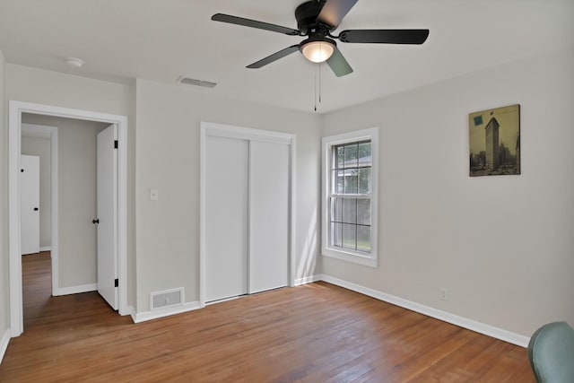 610 Phillips St, Cleburne, TX 76033 - unfurnished bedroom featuring baseboards, wood finished floors, a closet, and a ceiling fan