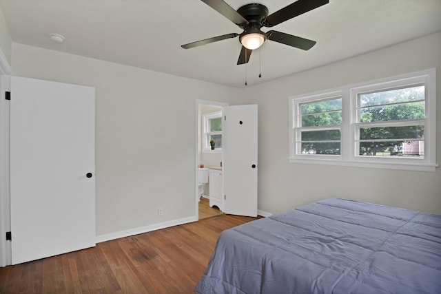 610 Phillips St, Cleburne, TX 76033 - bedroom featuring wood finished floors, baseboards, connected bathroom, and ceiling fan