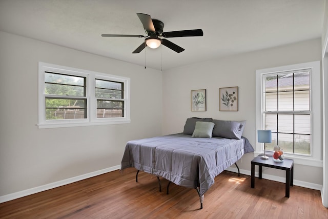 610 Phillips St, Cleburne, TX 76033 - bedroom featuring multiple windows, wood finished floors, baseboards, and ceiling fan