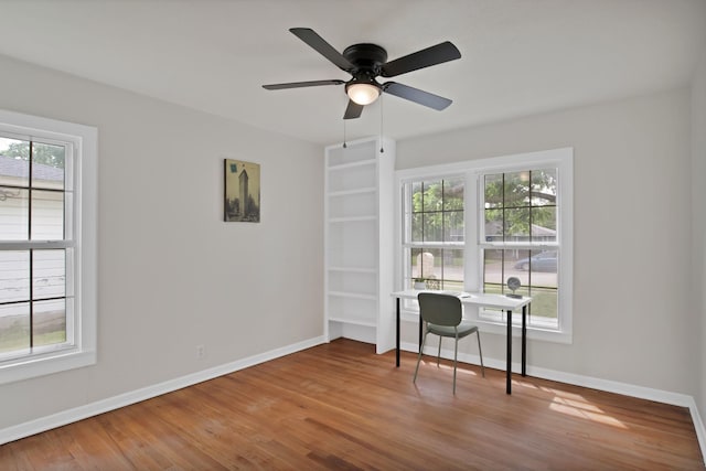 610 Phillips St, Cleburne, TX 76033 - home office with wood finished floors, baseboards, a ceiling fan, and built in features