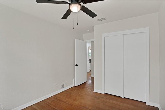 610 Phillips St, Cleburne, TX 76033 - unfurnished bedroom with wood finished floors, baseboards, and a ceiling fan