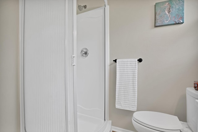 610 Phillips St, Cleburne, TX 76033 - bathroom with a stall shower, toilet, and baseboards