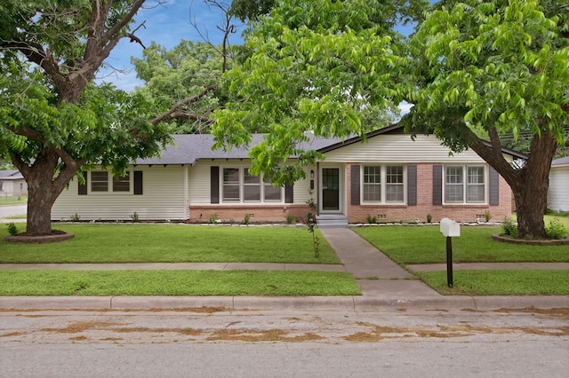610 Phillips St, Cleburne, TX 76033 - ranch-style home with brick siding, a front lawn, and entry steps
