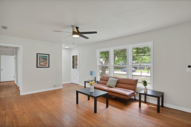610 Phillips St, Cleburne, TX 76033 - living room featuring ceiling fan, hardwood / wood-style floors, and baseboards