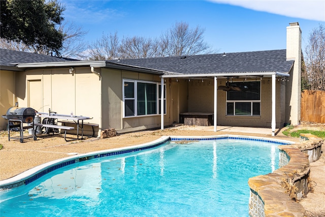 view of swimming pool with a patio, ceiling fan, fence, and a grill