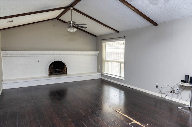 unfurnished living room with a ceiling fan, a brick fireplace, wood-type flooring, baseboards, and a textured ceiling
