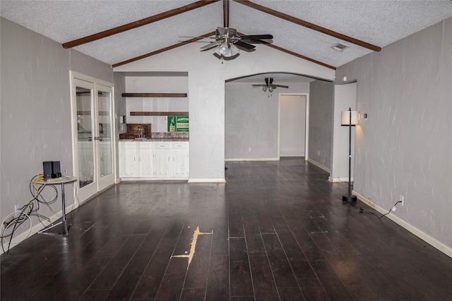 unfurnished living room featuring a ceiling fan, a textured ceiling, and wood finished floors