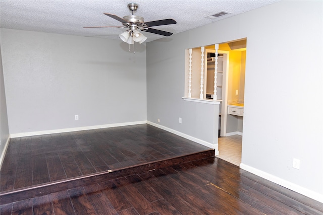 unfurnished room featuring ceiling fan, wood-type flooring, baseboards, and a textured ceiling