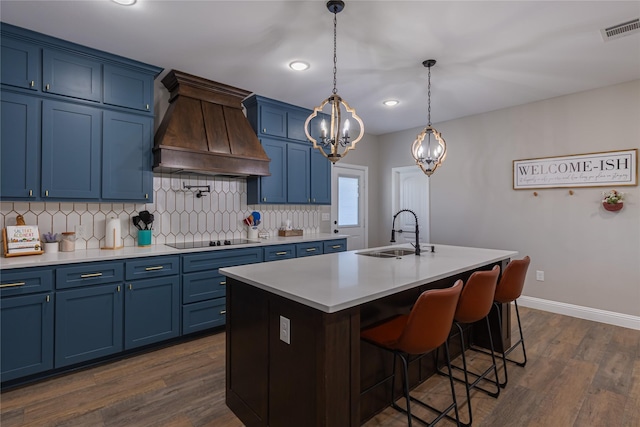 117 Rock Salt Dr, Springtown, TX 76082 - kitchen with a sink, blue cabinetry, custom exhaust hood, black electric stovetop, and recessed lighting
