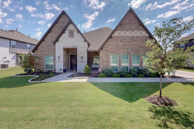 308 Secretariat, Hickory Creek, TX 75065 - view of front of property featuring a front yard, cooling unit, brick siding, and stone siding