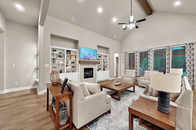 308 Secretariat, Hickory Creek, TX 75065 - living room featuring beamed ceiling, baseboards, a fireplace, ceiling fan, and light wood-style floors