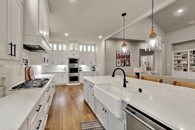 308 Secretariat, Hickory Creek, TX 75065 - kitchen with stainless steel appliances, a sink, light countertops, light wood finished floors, and recessed lighting