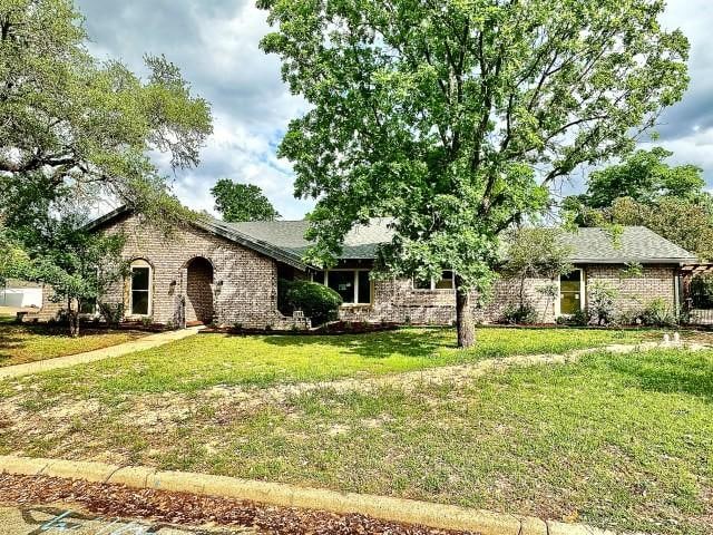 5409 Edinburgh Dr, Waco, TX 76710 - view of front of home featuring a front lawn and brick siding