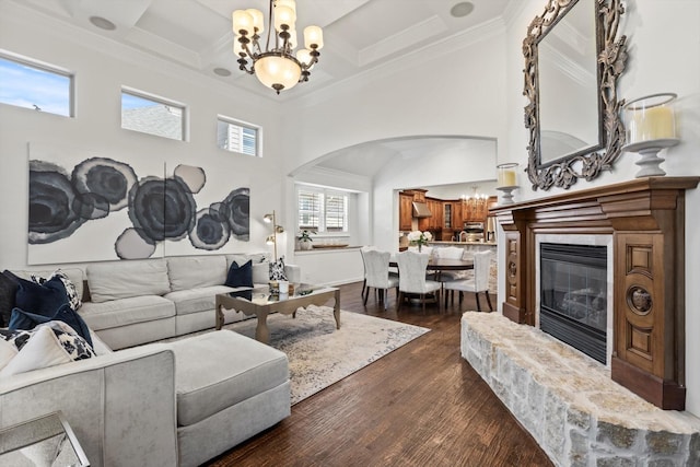 3063 Mitchell Way, The Colony, TX 75056 - living area featuring a chandelier, arched walkways, a towering ceiling, dark wood-type flooring, and crown molding