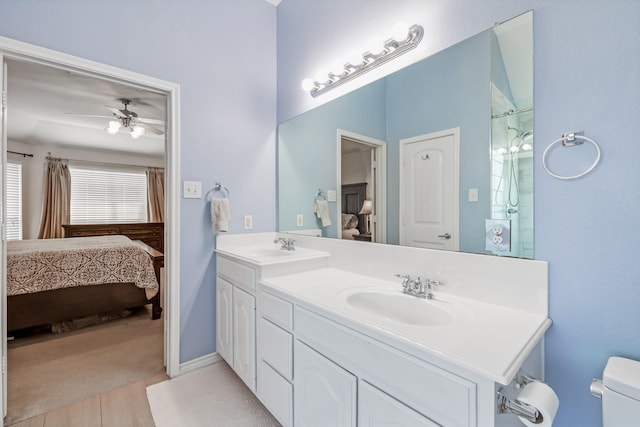 3601 Carmel Mountain Dr, Mckinney, TX 75070 - bathroom with connected bathroom, toilet, wood finished floors, ceiling fan, and double vanity