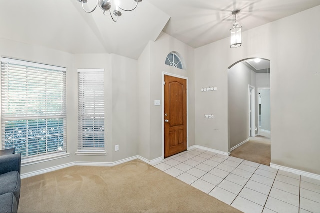 3601 Carmel Mountain Dr, Mckinney, TX 75070 - entryway with light colored carpet, arched walkways, light tile patterned floors, baseboards, and a chandelier