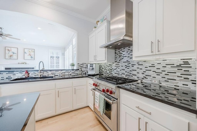 513 Suncreek Dr, Allen, TX 75013 - kitchen with wall chimney exhaust hood, luxury stove, a sink, ornamental molding, and tasteful backsplash