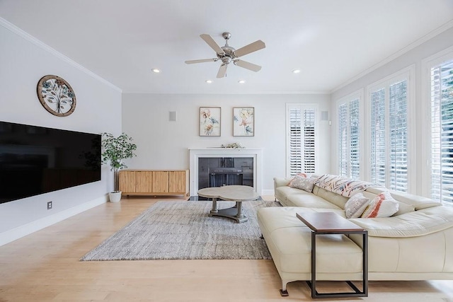 513 Suncreek Dr, Allen, TX 75013 - living area with wood finished floors, a fireplace with flush hearth, a ceiling fan, ornamental molding, and recessed lighting