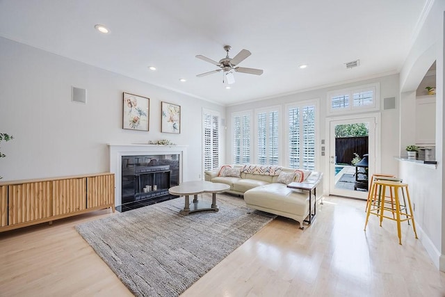 513 Suncreek Dr, Allen, TX 75013 - living area with light wood finished floors, a ceiling fan, ornamental molding, a premium fireplace, and recessed lighting