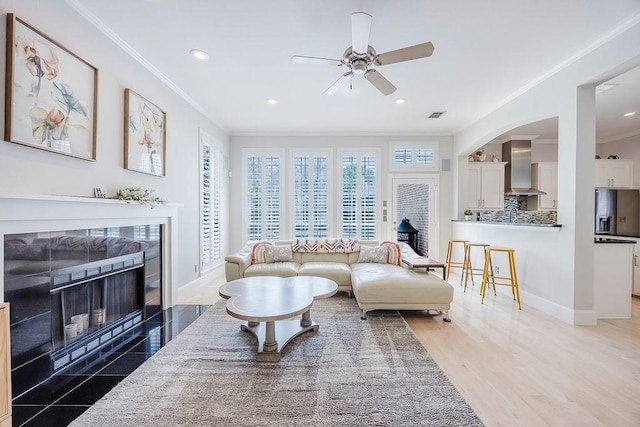 513 Suncreek Dr, Allen, TX 75013 - living area featuring ornamental molding, ceiling fan, a fireplace with flush hearth, recessed lighting, and baseboards