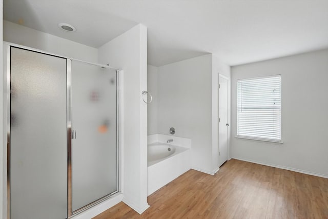10748 Irish Glen Trl, Fort Worth, TX 76052 - bathroom with a bath, wood finished floors, and a shower stall