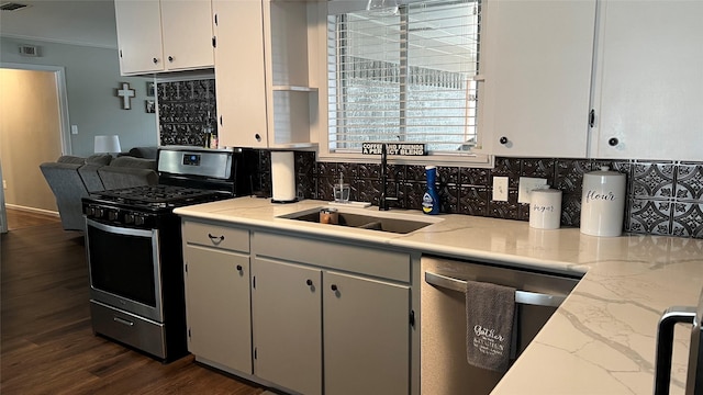 501 Linda Kay Dr, Winnsboro, TX 75494 - kitchen featuring stainless steel appliances, a sink, decorative backsplash, dark wood-type flooring, and crown molding