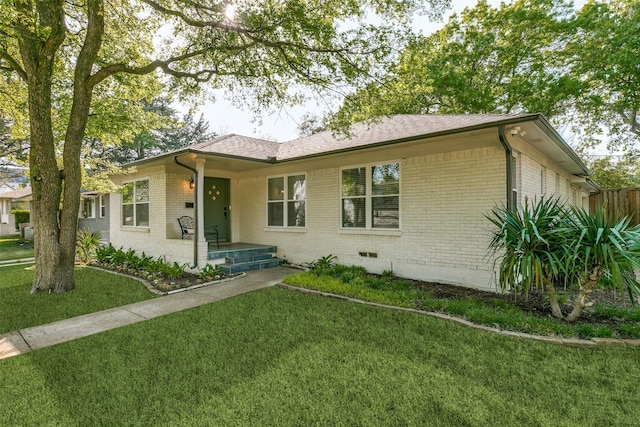 6663 Yosemite Ln, Dallas, TX 75214 - single story home featuring brick siding, a front yard, a shingled roof, and crawl space