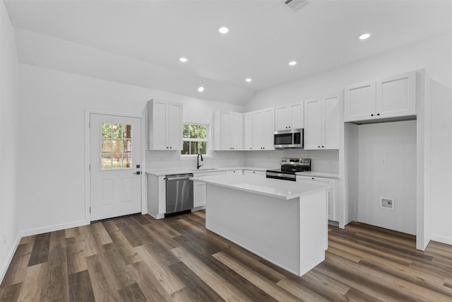 1612 Cheyenne Trl, Granbury, TX 76048 - kitchen with stainless steel appliances, dark wood-style floors, tasteful backsplash, white cabinets, and light countertops