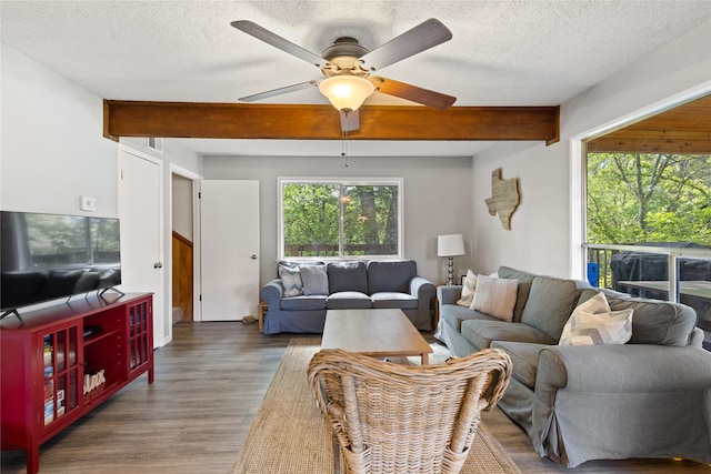 107 Nob Hill Cir, Malakoff, TX 75148 - living room with wood finished floors, a ceiling fan, beamed ceiling, and a textured ceiling