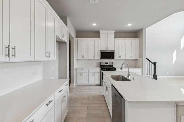 2929 Galveston St, Plano, TX 75075 - kitchen with a sink, appliances with stainless steel finishes, recessed lighting, tasteful backsplash, and light countertops