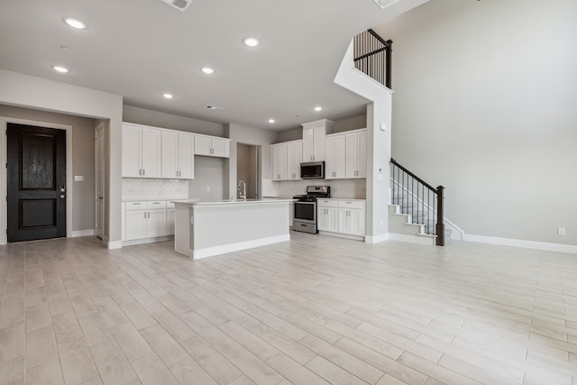 2929 Galveston St, Plano, TX 75075 - kitchen featuring appliances with stainless steel finishes, open floor plan, recessed lighting, baseboards, and light countertops