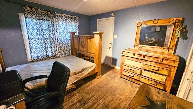 2404 Handley Dr, Fort Worth, TX 76112 - bedroom featuring a textured ceiling and wood finished floors