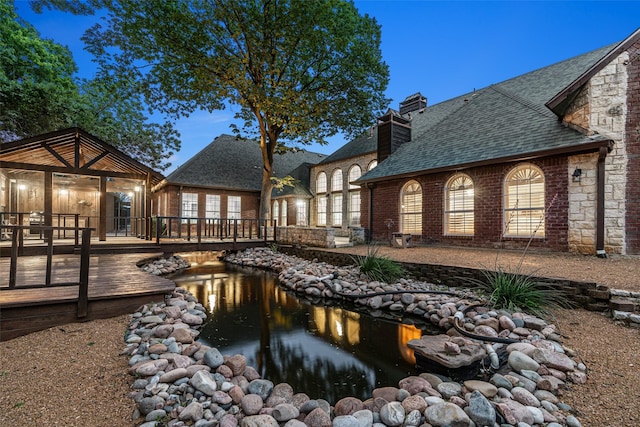 1201 Tralee Ln, Garland, TX 75044 - view of swimming pool with a wooden deck and a small pond