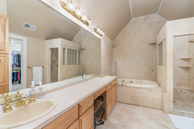 1201 Tralee Ln, Garland, TX 75044 - bathroom with lofted ceiling, tiled shower, a garden tub, double vanity, and a walk in closet