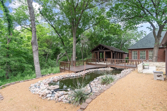 1201 Tralee Ln, Garland, TX 75044 - view of swimming pool with a garden pond and a deck