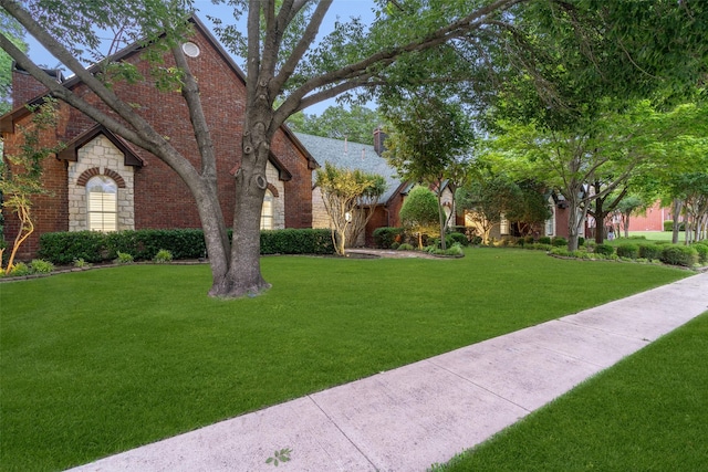 1201 Tralee Ln, Garland, TX 75044 - view of front of property featuring a front yard, stone siding, and brick siding