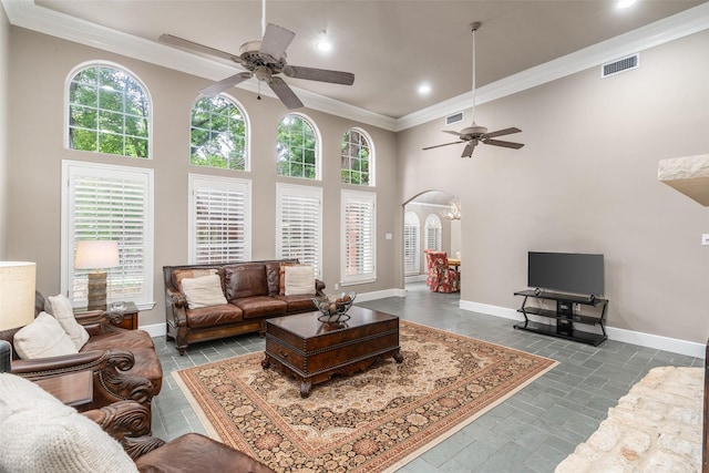 1201 Tralee Ln, Garland, TX 75044 - living room featuring ceiling fan, ornamental molding, arched walkways, recessed lighting, and a towering ceiling