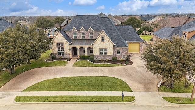 3316 Fairway Dr, Denton, TX 76226 - view of front facade featuring stone siding, a standing seam roof, a front lawn, a shingled roof, and a residential view
