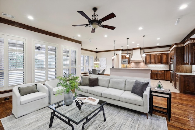 3316 Fairway Dr, Denton, TX 76226 - living room featuring healthy amount of natural light, ceiling fan, light wood finished floors, recessed lighting, and crown molding