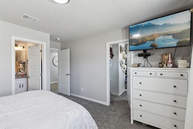 5816 Grayson St, Fort Worth, TX 76119 - bedroom featuring a walk in closet, dark colored carpet, baseboards, ensuite bathroom, and a closet