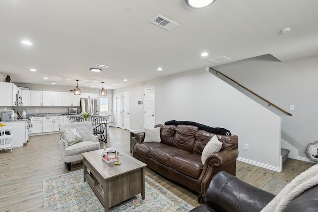 5816 Grayson St, Fort Worth, TX 76119 - living area with recessed lighting, stairs, light wood-style floors, and baseboards