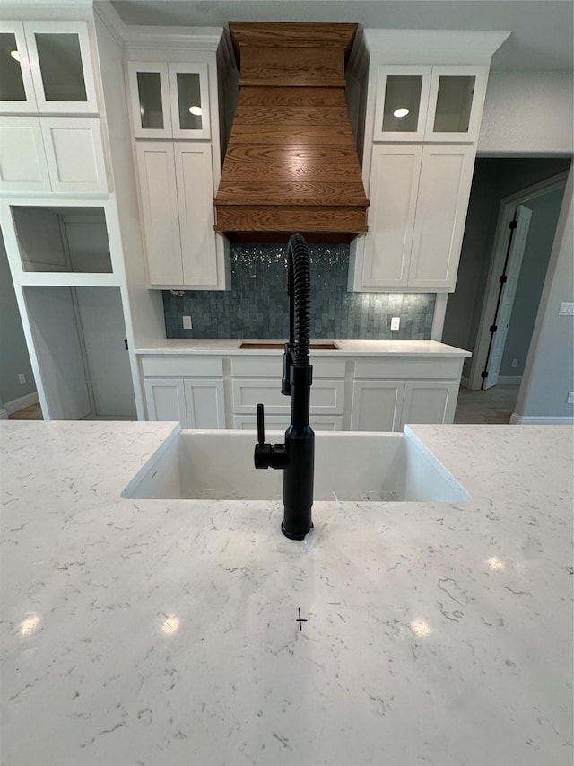 544 Aermotor Loop, Weatherford, TX 76085 - kitchen featuring white cabinetry, backsplash, and glass insert cabinets